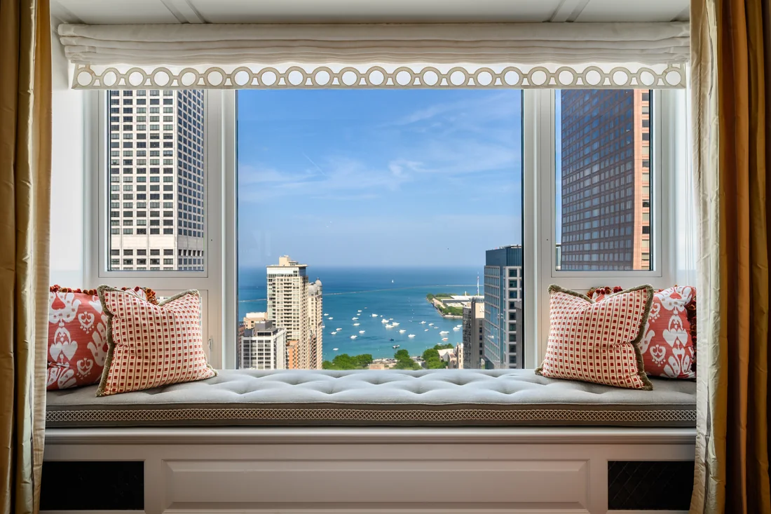Cushioned window seat framing Lake Michigan and nearby buildings