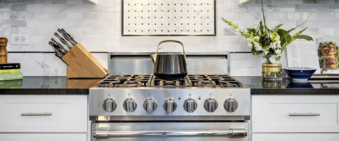 Kitchen detail with stainless steel range and clean stone counters